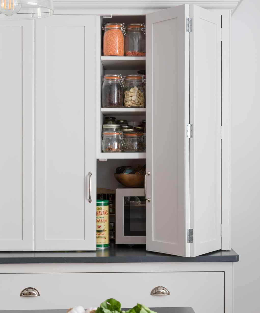 Small white kitchen ideas with bi-fold doors on a white cupboard