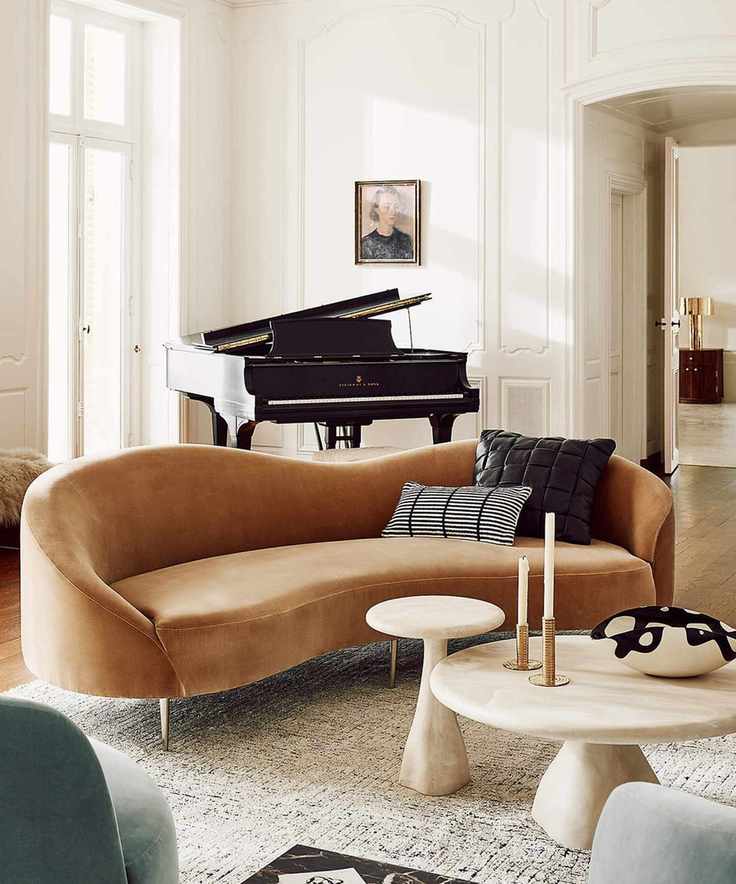 neutral traditional living room with panelled walls, and a camel velvet curved couch