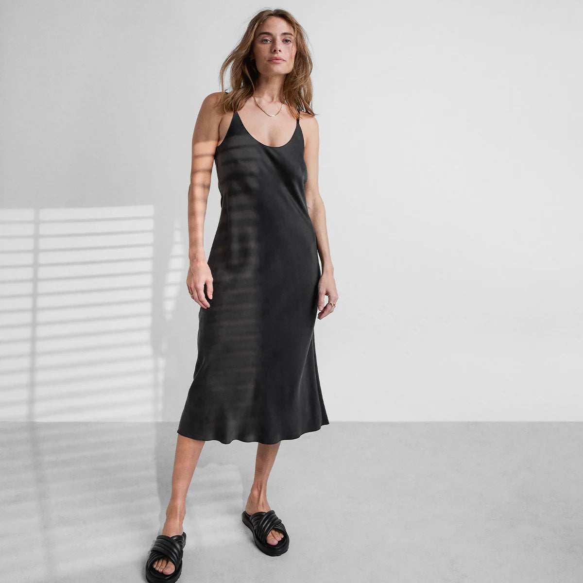 Woman in an elegant black sleepwear dress