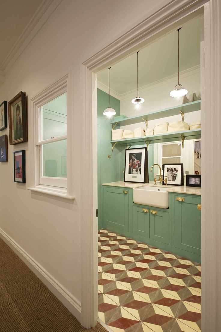Stylish utility room with mosaic flooring and an internal window