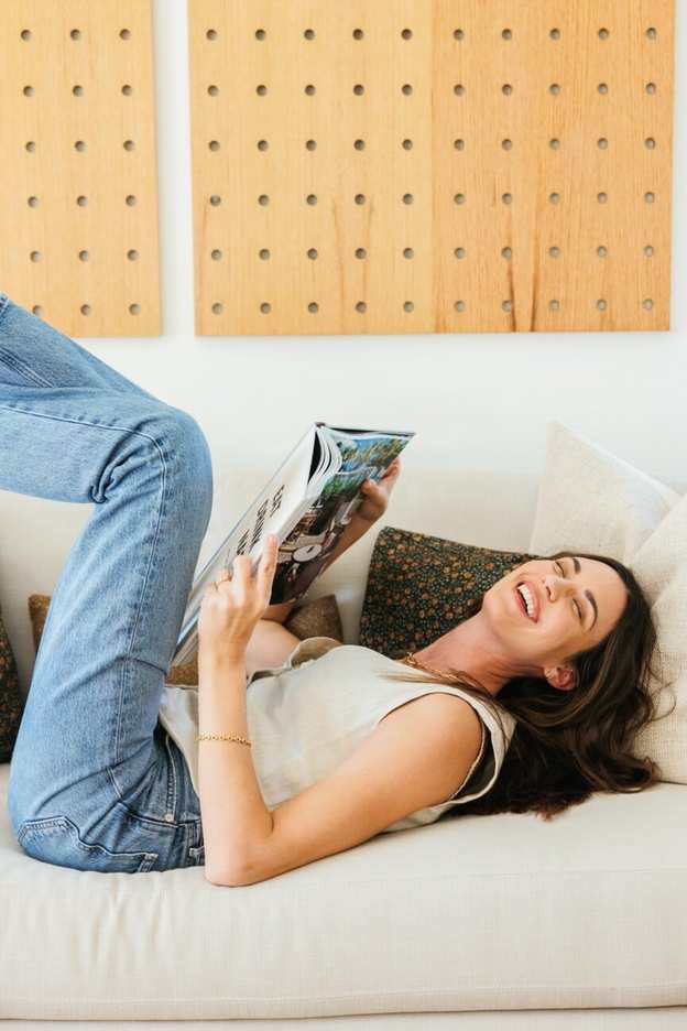 woman laughing reading book_dopamine and hormone connection