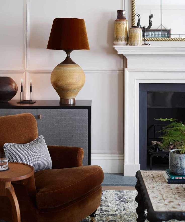living room with sofa, fireplace and large table lamp