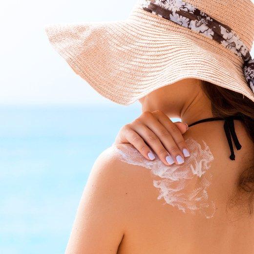 Woman applying mineral sunscreen to body