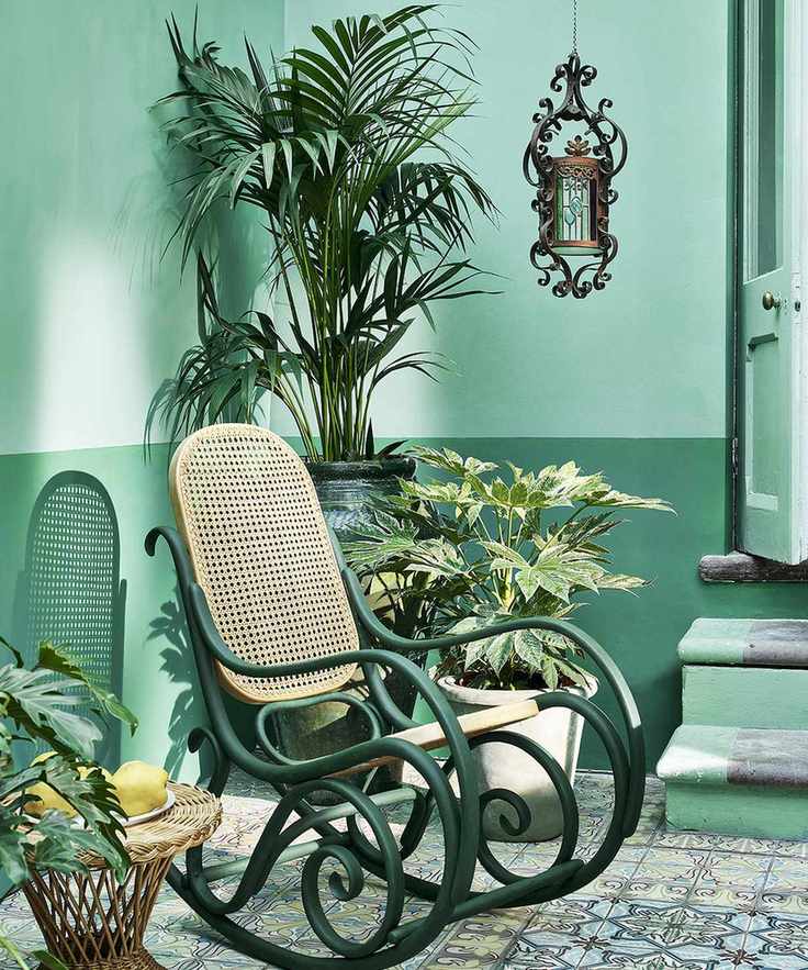 tiled terrace painted green with plants and rocking chair