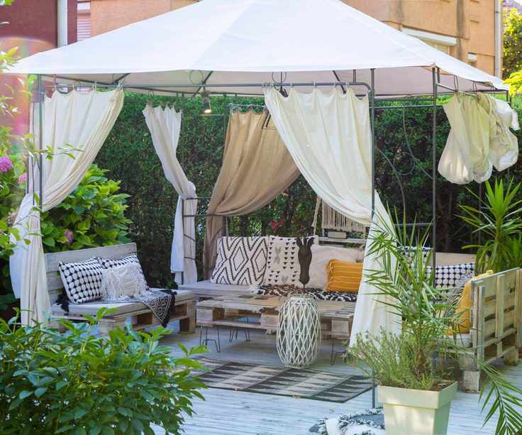 A modern gazebo with wooden sofas