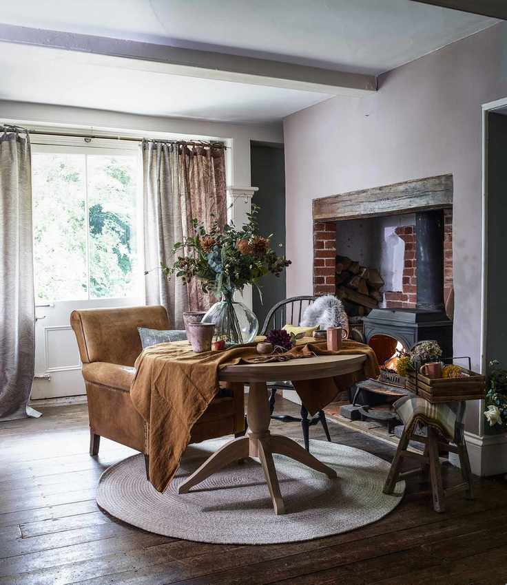 leather chair and round table in country room with fireplace