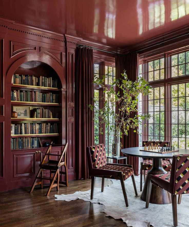 dark cherry red color-drenched library room with large windows, walls, built-ins and ceiling in gloss finish