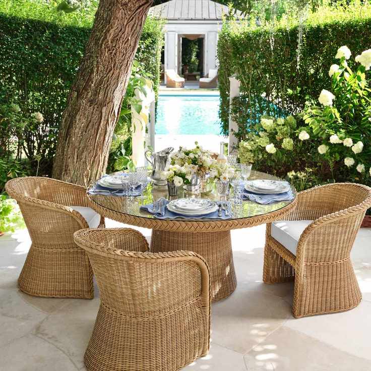 wicker furniture by. a pool