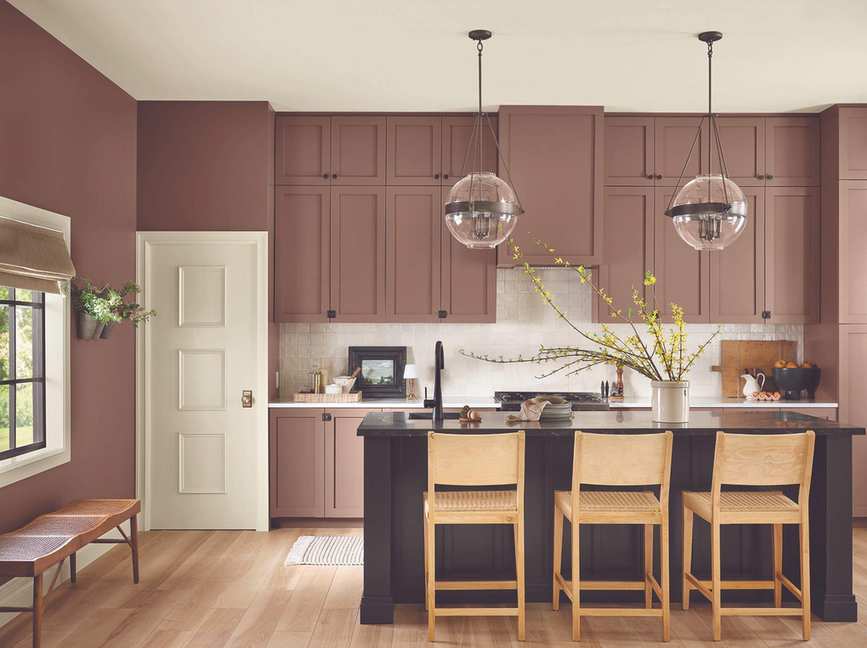 Dusty dark pink painted kitchen cabinets and hanging pendant lights