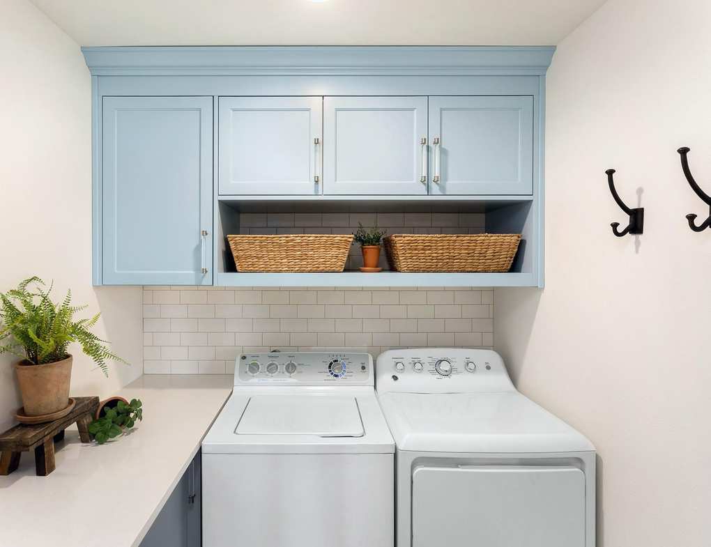 Tiny laundry room with wall hooks for organization.