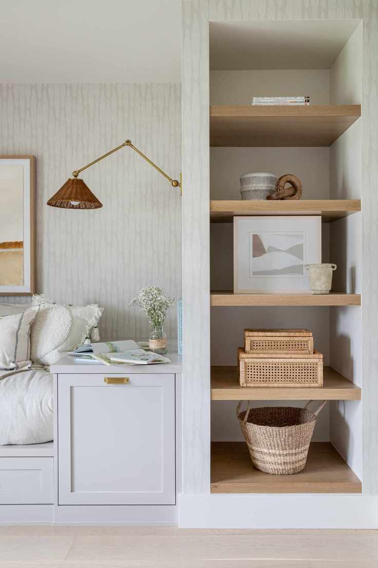 living room with alcove bookcase, built in sofa, wall light, wallpaper