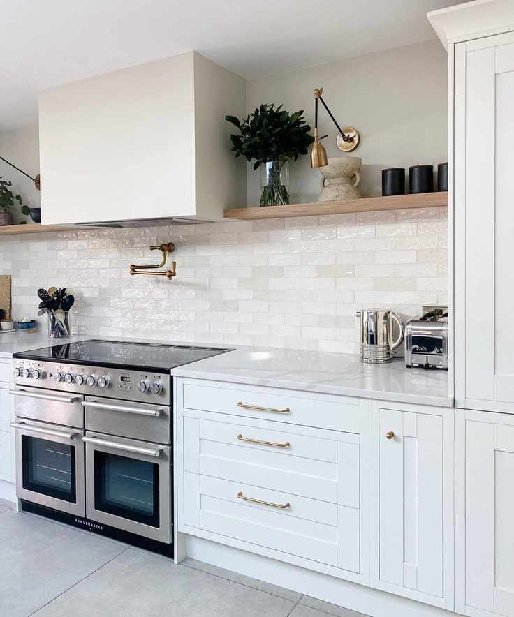 A bright kitchen featuring glossy white backsplash ideas in various tonal shades.