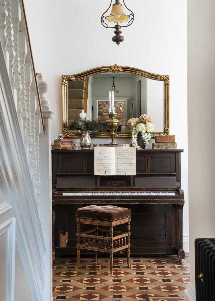 Hallway with piano and patterned tile floor