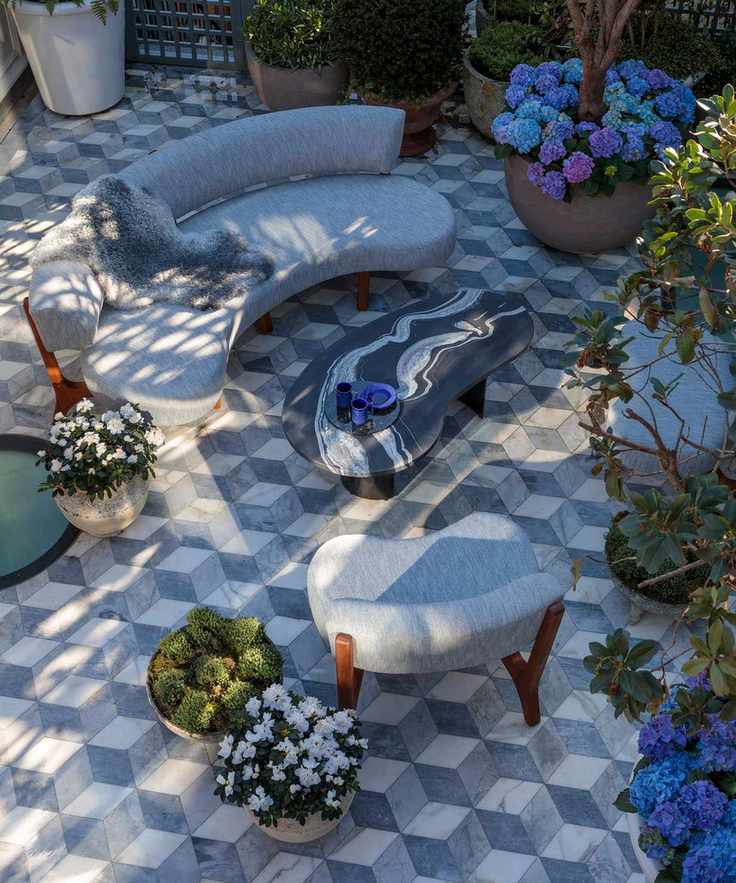 Curved furniture and geometric tiles enhance small gardens