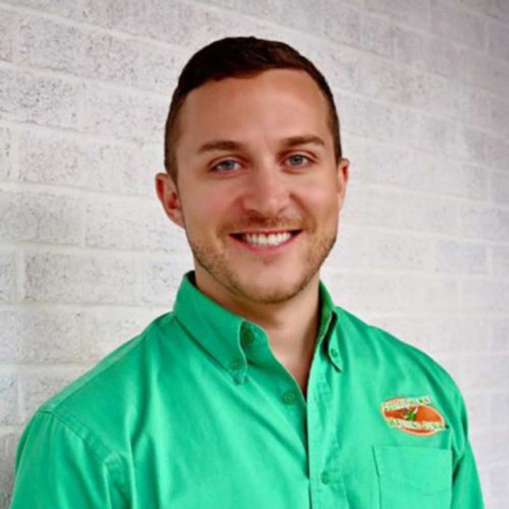 headshot of Nick Friedman a man with a green shirt and dark hair
