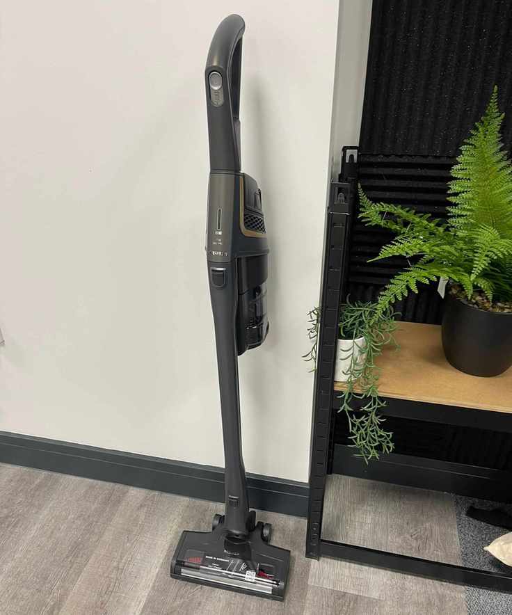 Miele Triflex HX2 Pro leaning against white wall