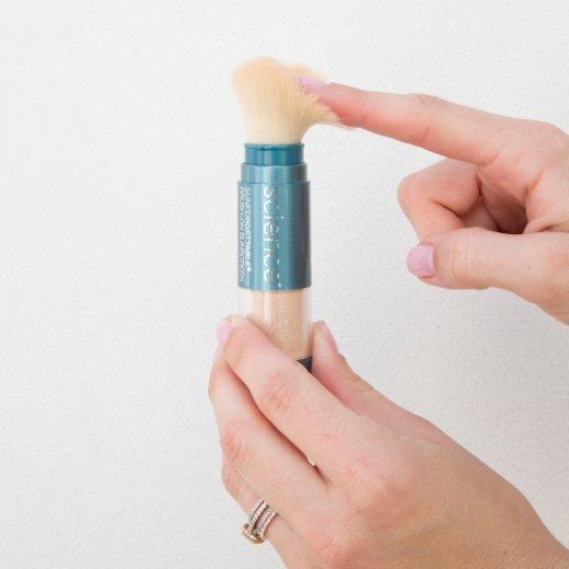 Image of hand model holding Brush-On Shield SPF 50