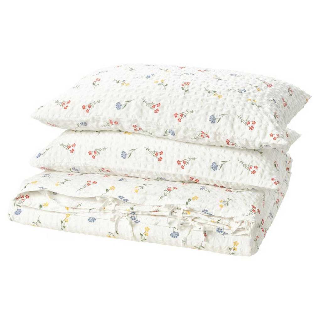 IKEA floral white PILDVÄRGMAL Duvet cover and pillowcases folded in a pile