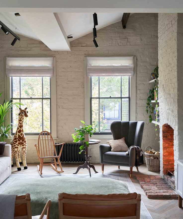 Beige living room with a colorful accent wall and eclectic furniture.