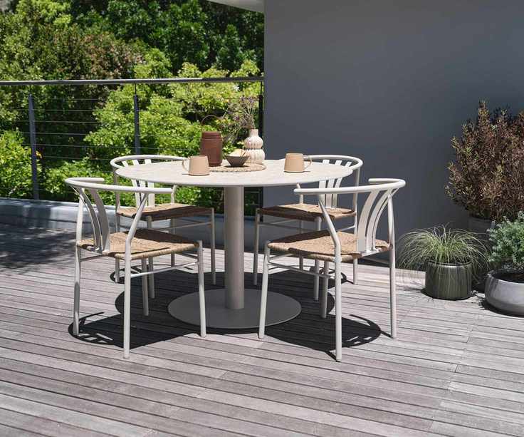 garden dining set on deck with container plants