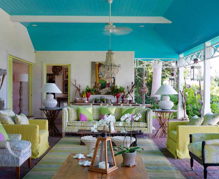 Vibrant outdoor terrace with a bright blue ceiling and colorful furnishings