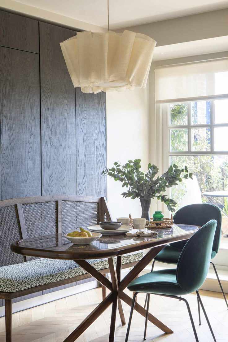 dining room area with main pendant light, bench seating and chairs, parquet wood floor
