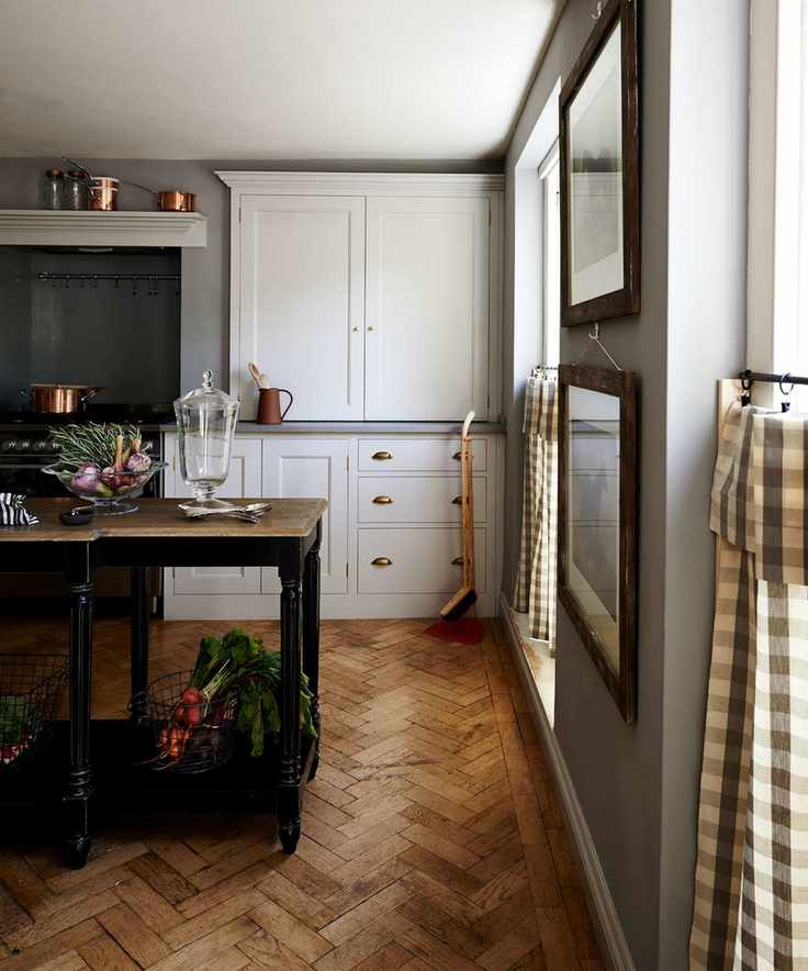Grey kitchen, white Shaker units, parquet flooring, console table as island unit, windows with half window check curtains