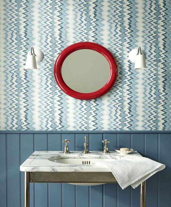 Red mirror in a blue bathroom