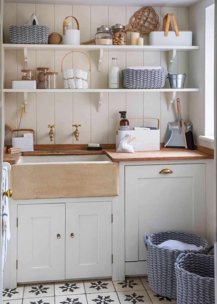 Laundry room featuring open shelving in a bright white design.