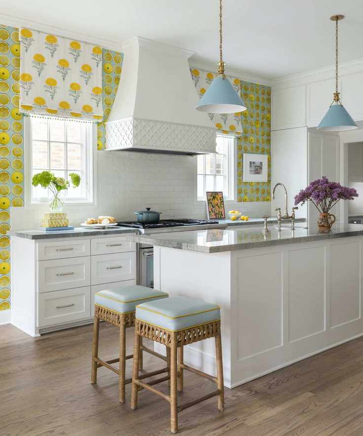 white kitchen island with lemon wallpaper and marigold print blinds behind