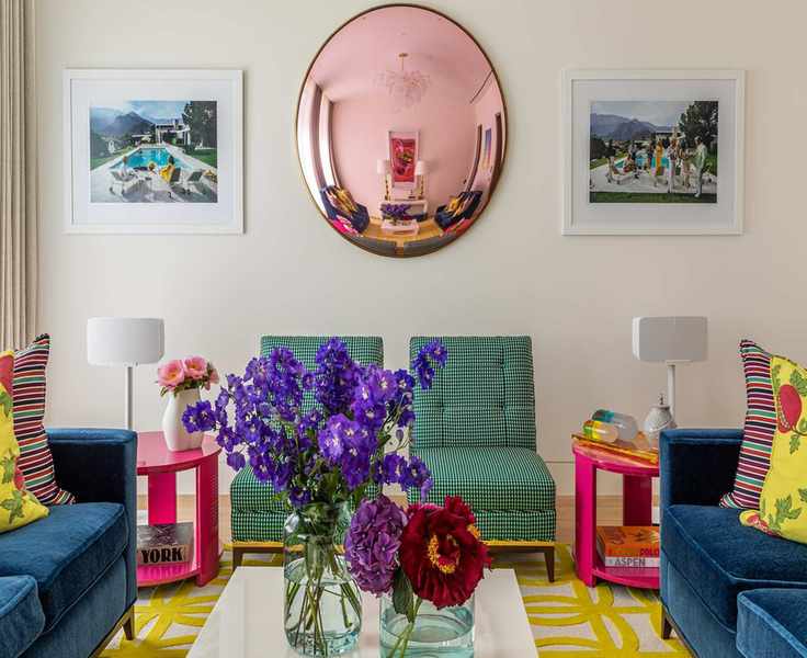 living room with armchairs, rug and mirror