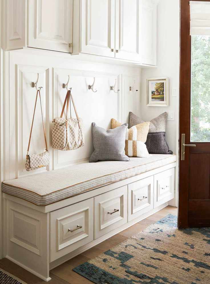 Small white entryway with bespoke storage and wood floor