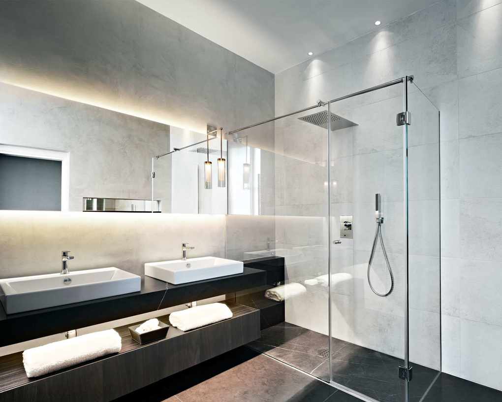 Bathroom with LED strip lighting and light gray wall tiles