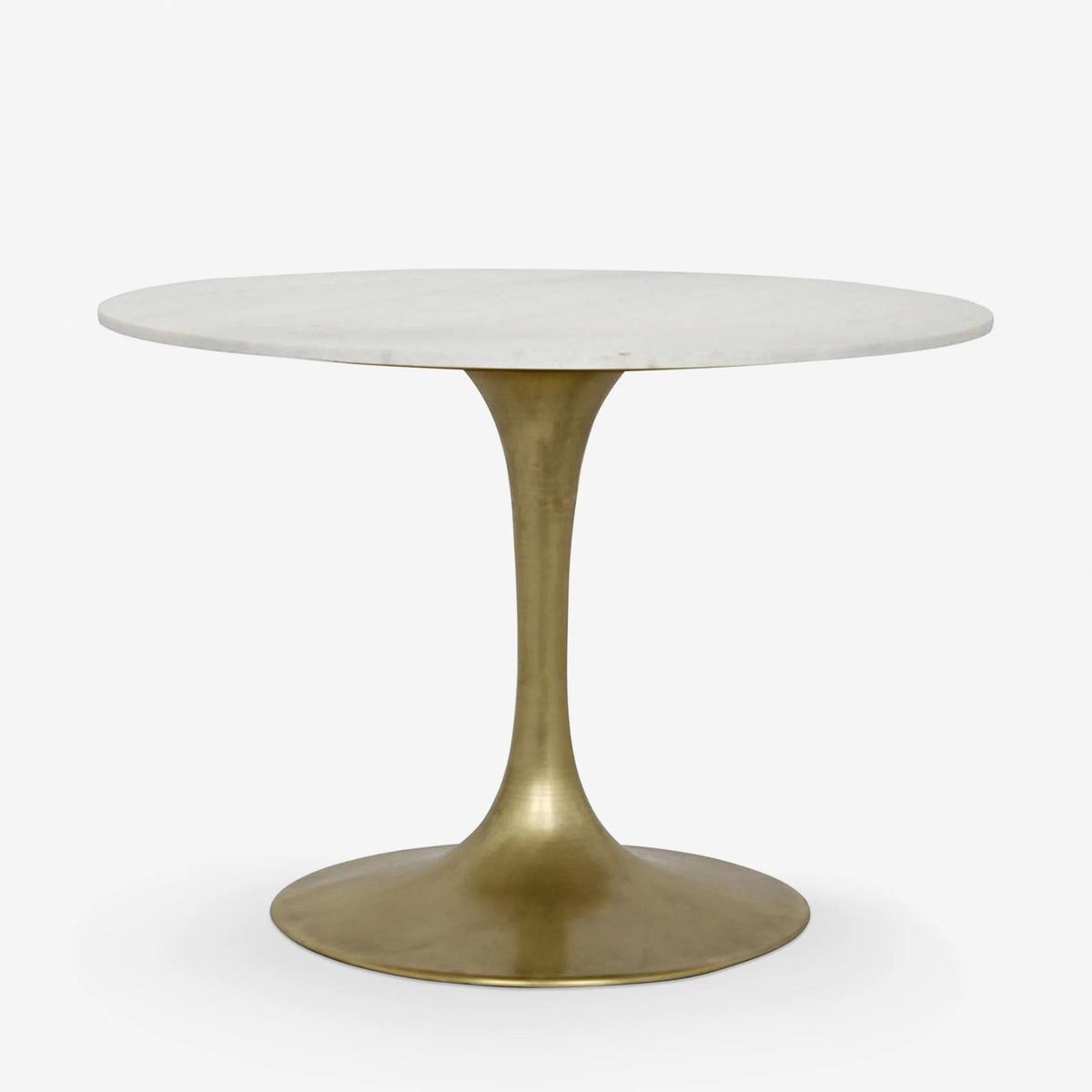 Lulu and Georgia Lillia Round Dining Table against a white background.
