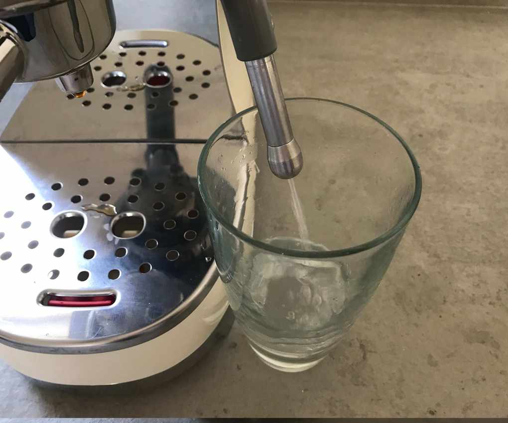The water spout pouring water into a glass