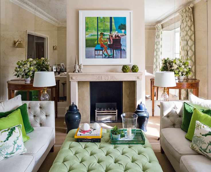 A living room mirror idea with floor-to-ceiling mirrored walls either side of the fireplace