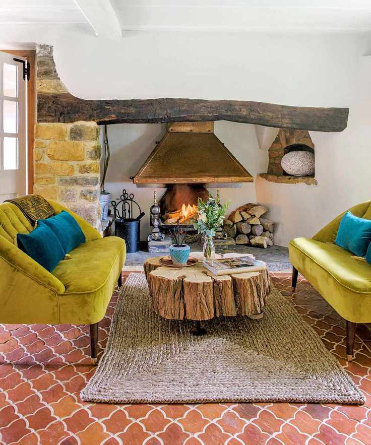 A stylish living room featuring a lit fire in an inglenook fireplace with comfortable seating.