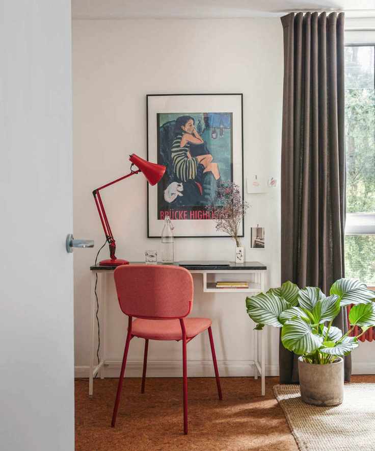 beige home office with red chair