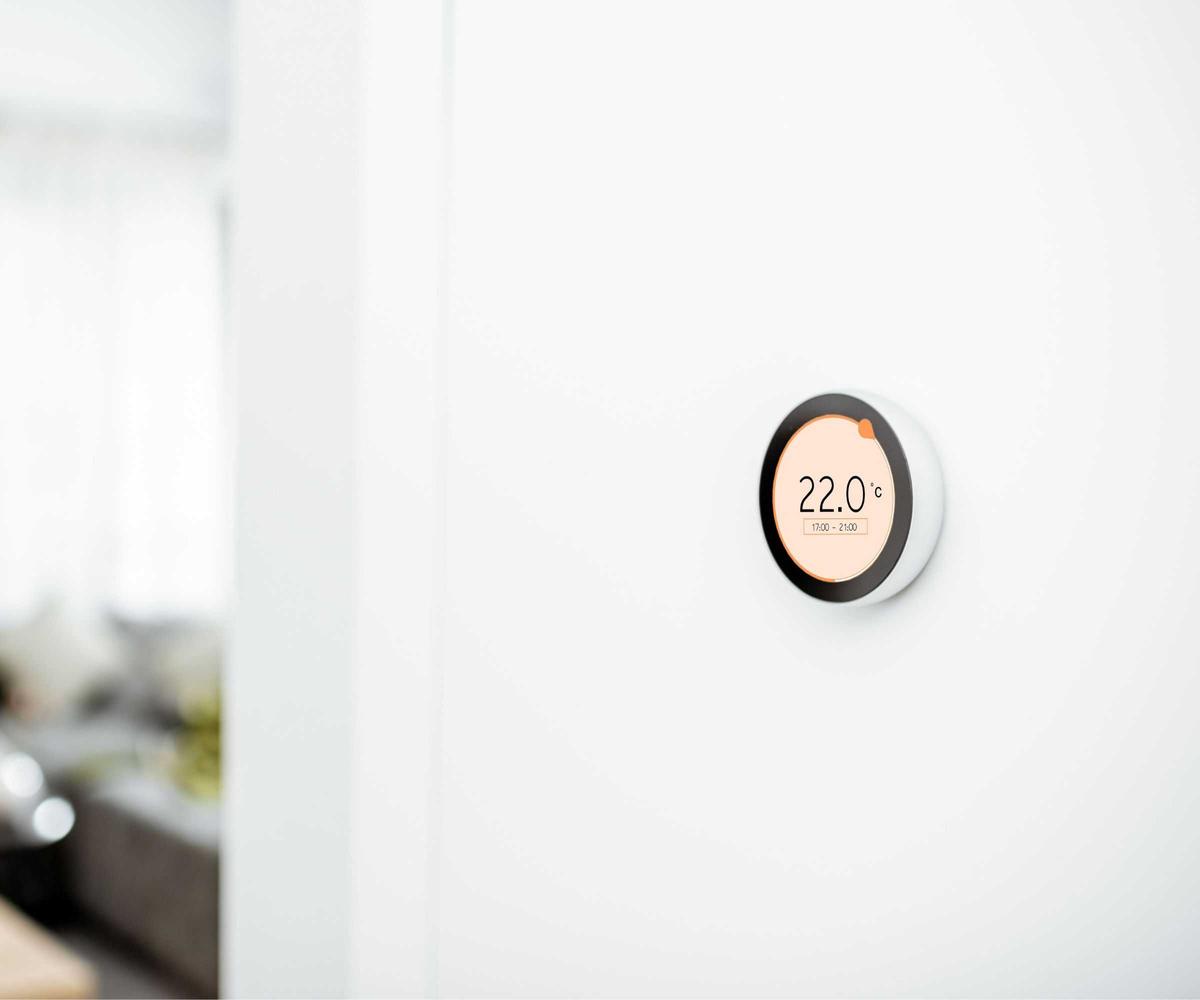 Smart thermostat on a white wall.