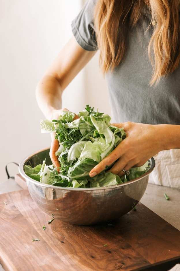 Tossing green salad.