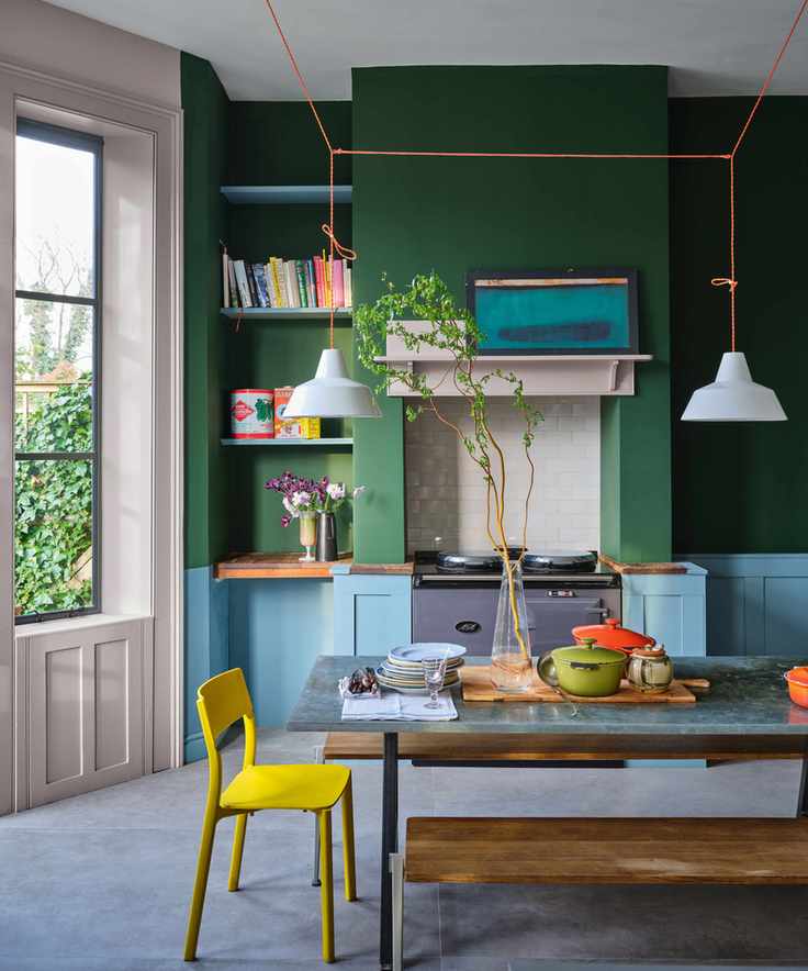 kitchen with painted green walls and pale blue cabinets