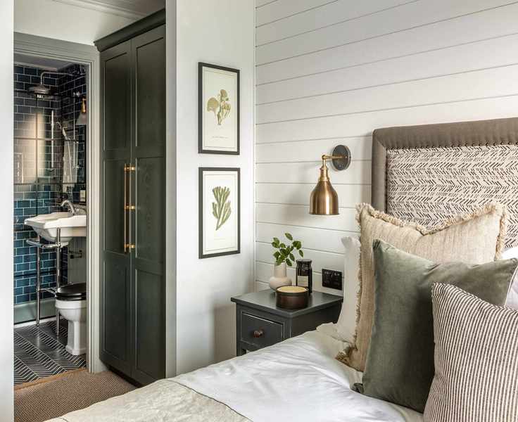 White bedroom with shiplap wall and ensuite bathroom