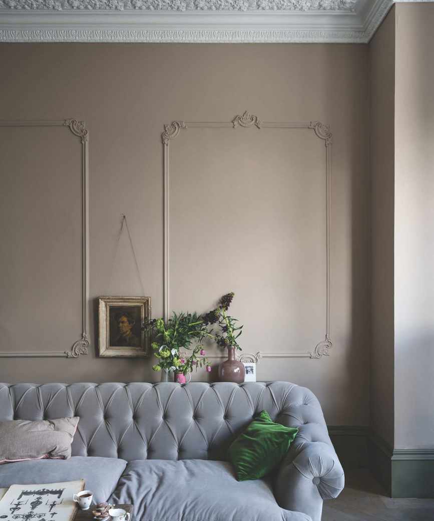 A sitting room with Jitney painted walls and gray velvet furnishings.