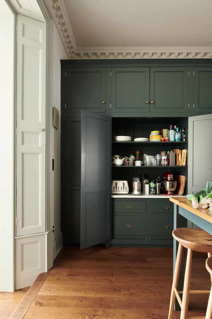 Dark green kitchen with pantry cupboard