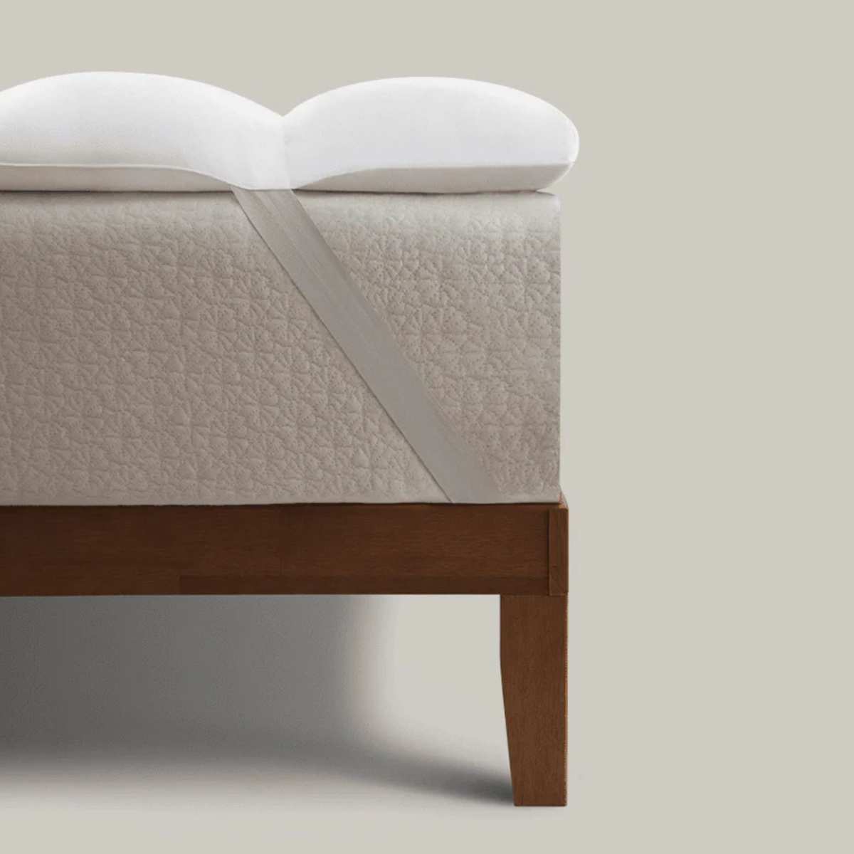 A Coop Sleep Goods Retreat Mattress Topper on a bed