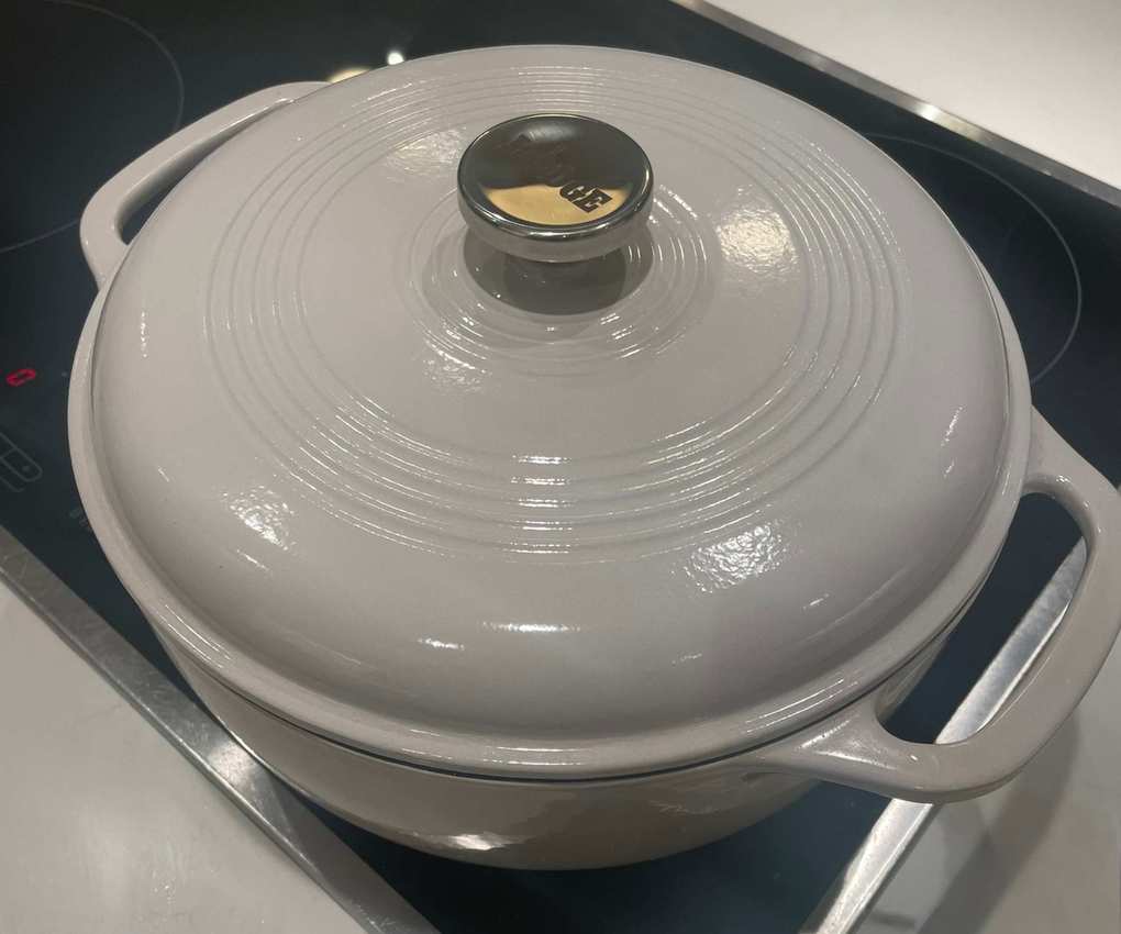 Sizzling chicken thighs and diced vegetables in the Lodge 6QT Enameled Cast Iron Dutch Oven with Lid in my test kitchen