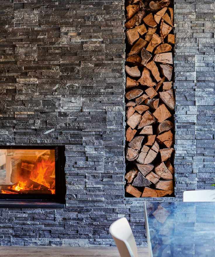 Slate clad chimneybreast with inset fire and log storage