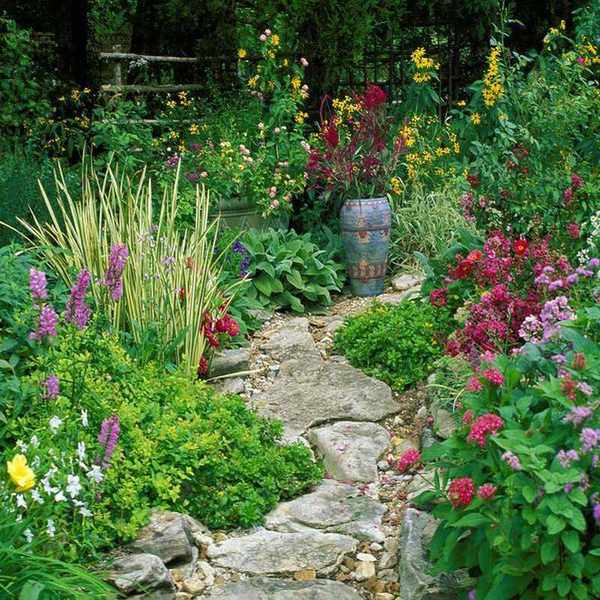 winding path made of rocks in flower garden