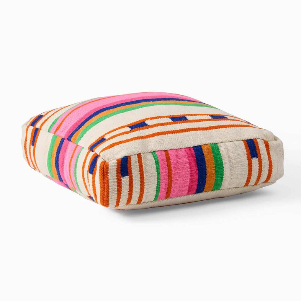 White floor cushion with pink, orange, blue and green stripes