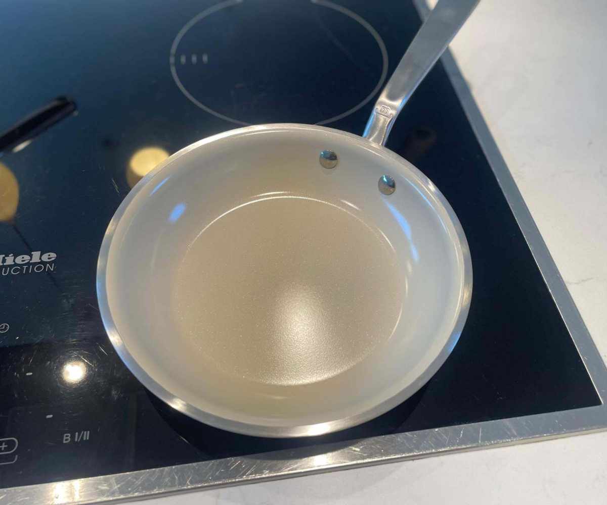 Made In CeramiClad™ Non-Stick Frying Pan on a black stovetop. 